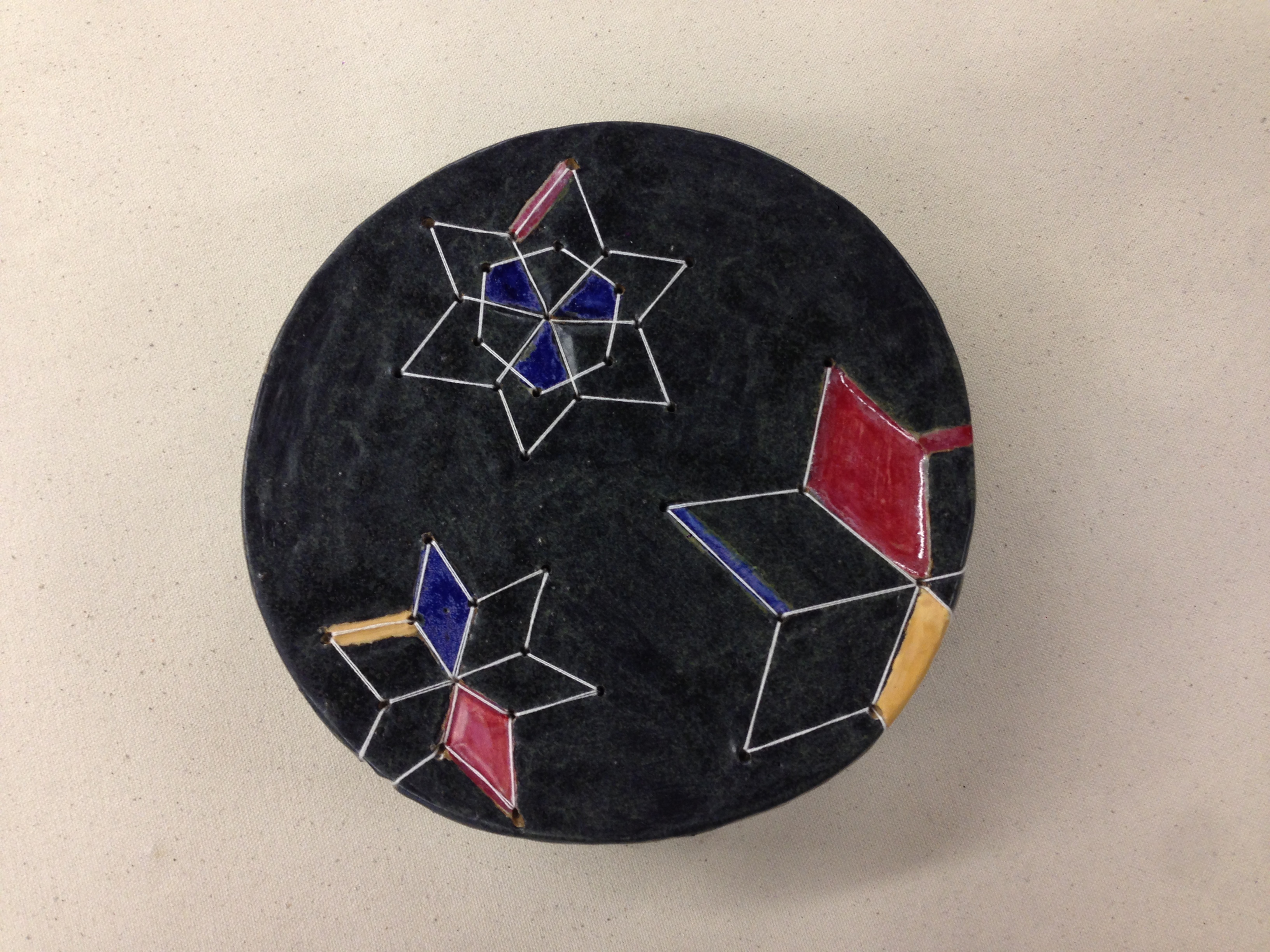 Honor Song — ceramic plate with Lakota star quilt geometric patterns in cobalt, crimson, and gold on dark slate glaze