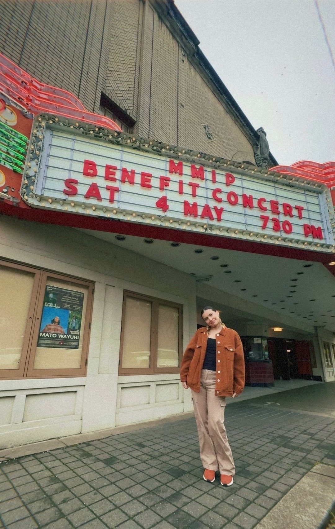 Julia outside the Whiteside Theater marquee reading MMIP Benefit Concert